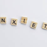 Scrabble titles spelling out "anxiety"