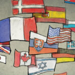 A man and a woman talk with illustrations of different counties' flags moving between them.